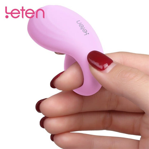 Close-up of a wearable silicone finger vibrator toy being worn on a hand